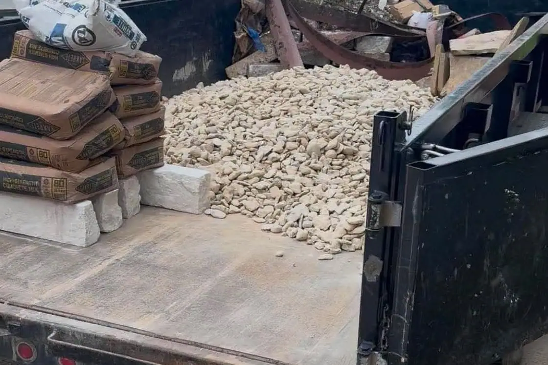 Dump trailer loaded with stone, rock and project materials